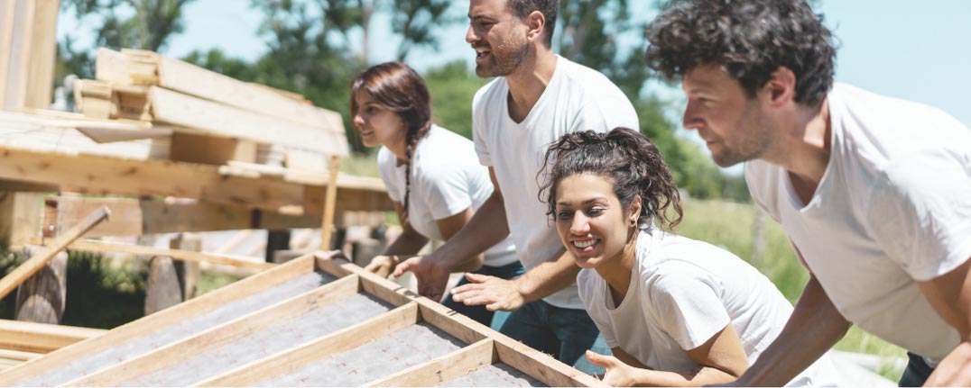 Group of people building a house